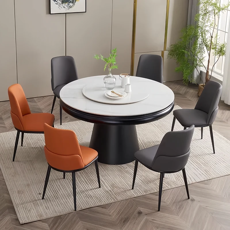 Table de salle à manger ronde avec plateau en pierre frittée et rallonge escamotable pivotante.