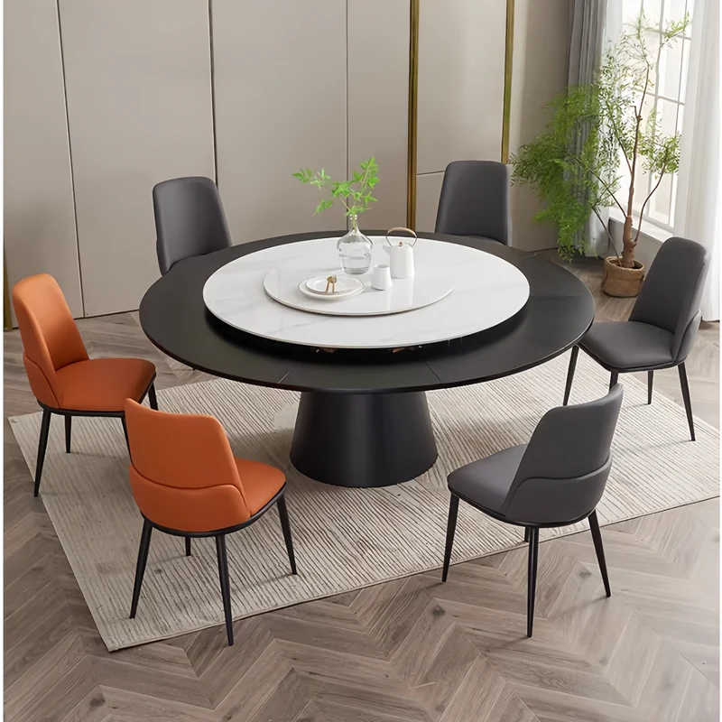Table de salle à manger ronde avec plateau en pierre frittée et rallonge escamotable pivotante.