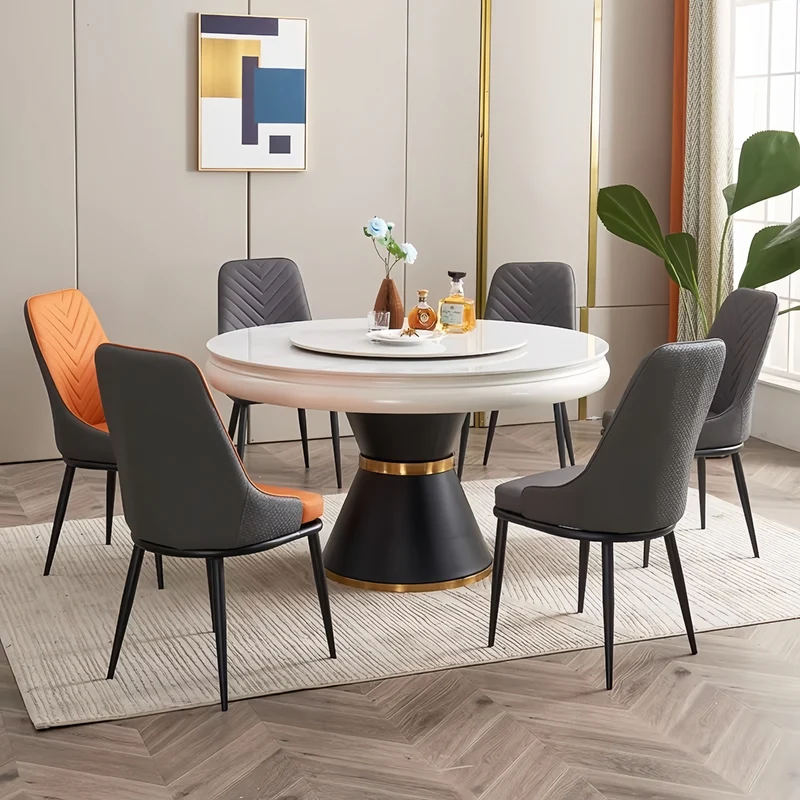 Table de salle à manger ronde avec plateau en pierre frittée et rallonge escamotable pivotante.