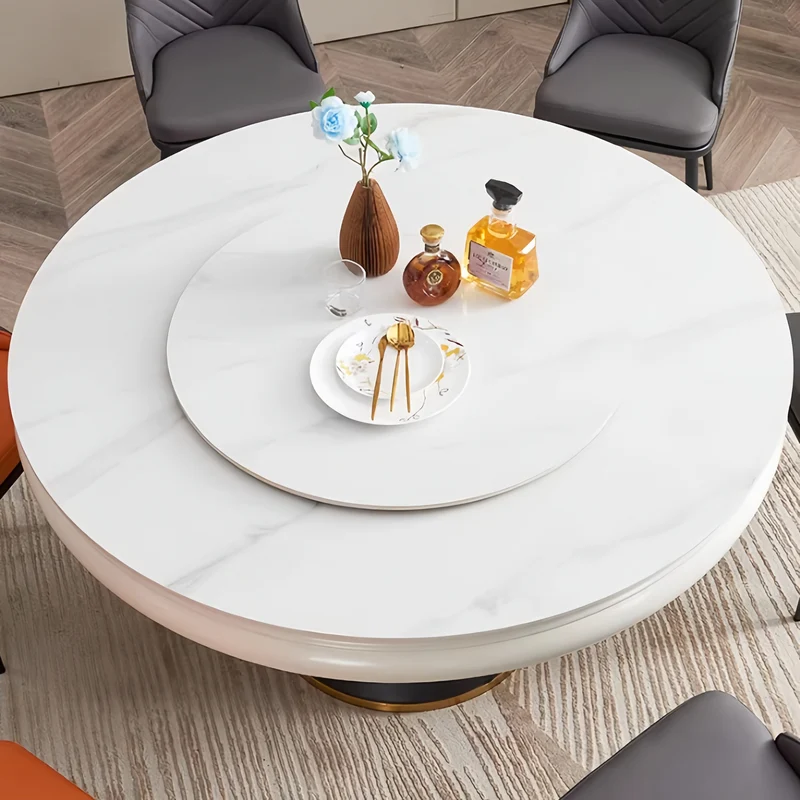 Table de salle à manger ronde avec plateau en pierre frittée et rallonge escamotable pivotante.