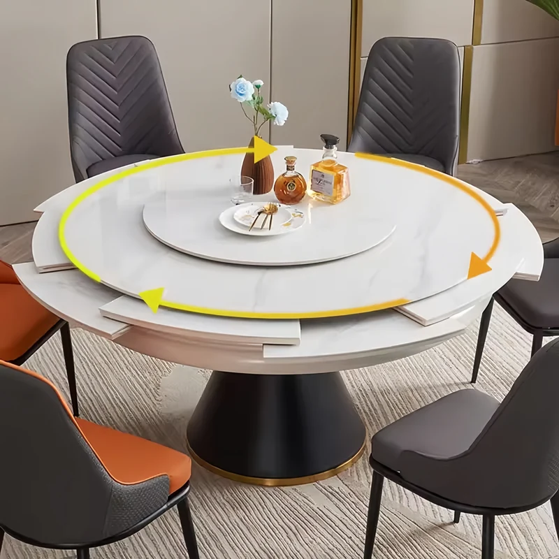 Table de salle à manger ronde avec plateau en pierre frittée et rallonge escamotable pivotante.