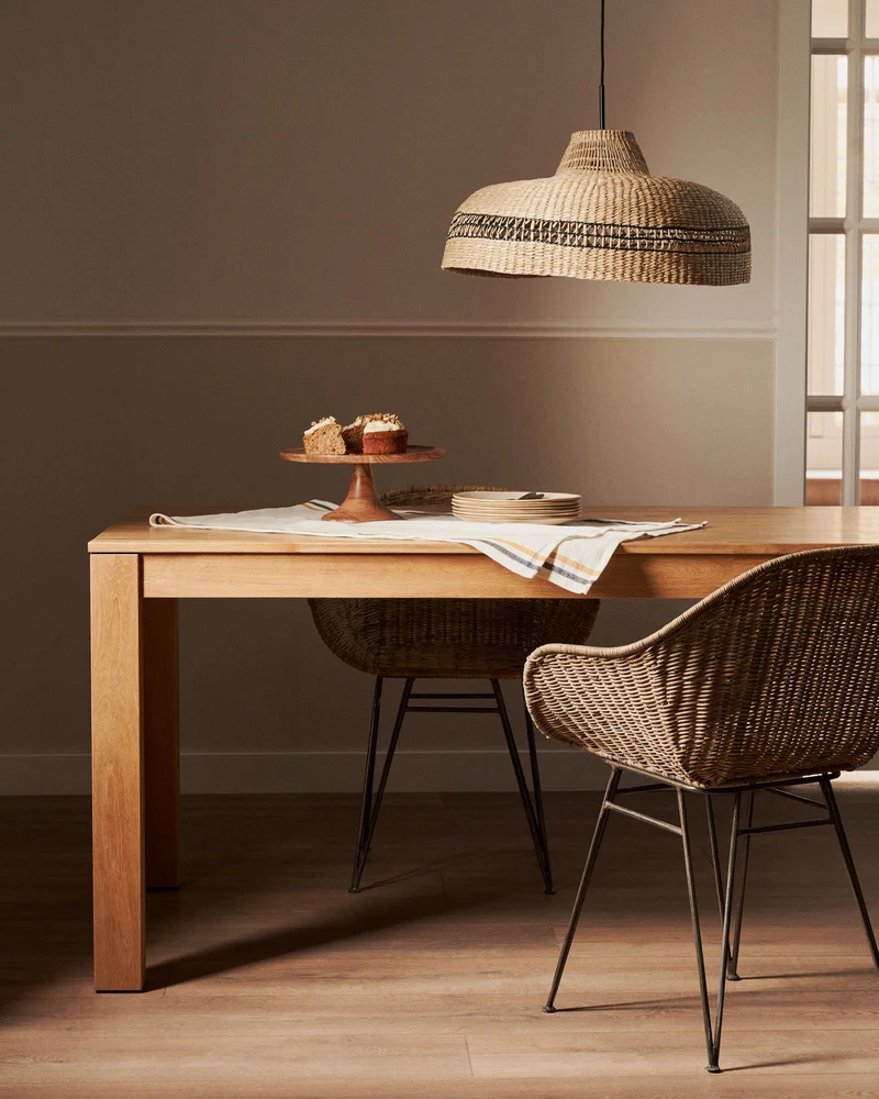 Chart chair made from rattan with black finished steel legs