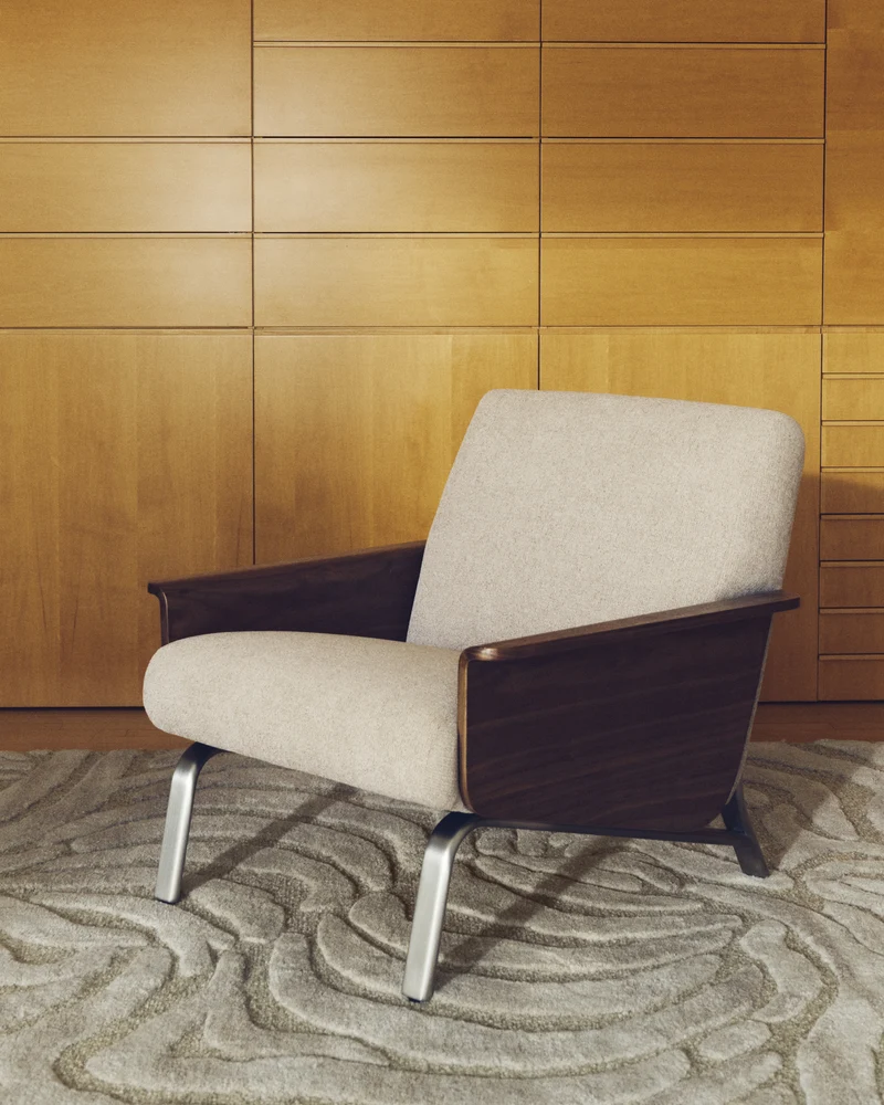 Amsen light brown armchair in walnut plywood with legs in brushed stainless steel